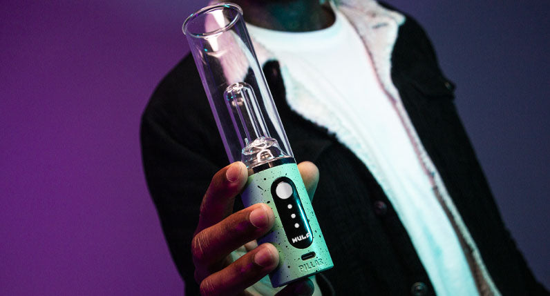 Man holding Wulf Pillar under purple and blue studio lighting